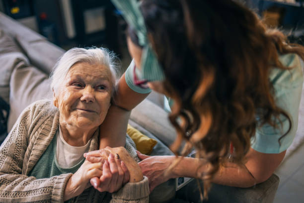 a nurse visits an elderly disabled woman at home and helps her