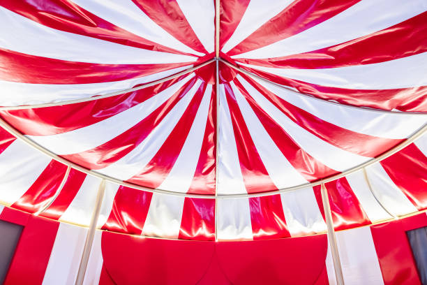 istock Circus tent background. Colorful design, striped white and red, retro style. 2012835187