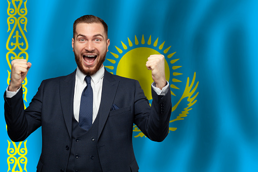 Kazakhstani happy businessman on the background of flag of Kazakhstan Business, education, degree and citizenship concept