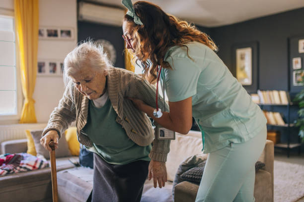 istock a nurse visits an elderly disabled woman at home and helps her 2012838455