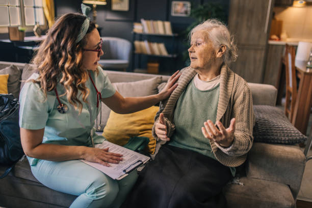 istock a nurse visits an elderly disabled woman at home and helps her 2012840537