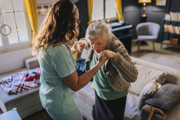 a nurse visits an elderly disabled woman at home and helps her