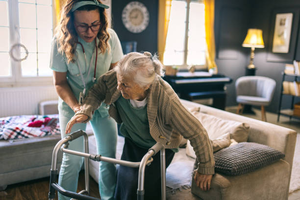istock a nurse visits an elderly disabled woman at home and helps her 2012841600