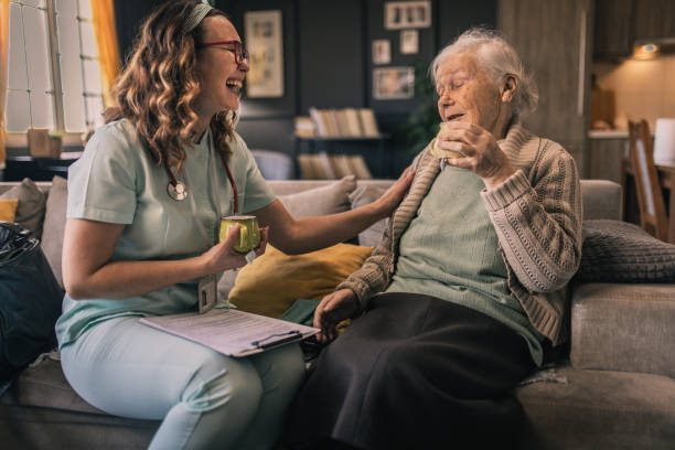 a nurse visits an elderly disabled woman at home and helps her - Photo