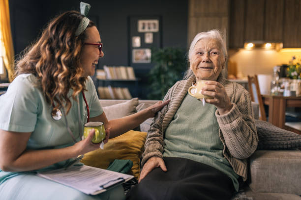 istock a nurse visits an elderly disabled woman at home and helps her 2012842721