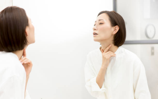 istock A woman touching her throat. 2012855303