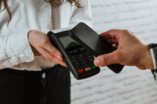 istock Mobile Payment By Male Customer For Female Retail Manager 2012882220