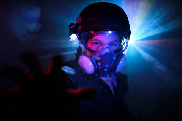 istock Kid in respirator committing crime in darkness 2012883460