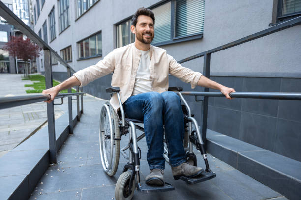 istock Disabled man on a wheelchair looking positive and smiling 2012887972