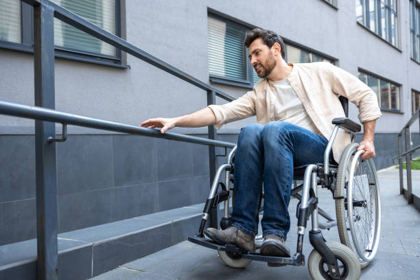 istock Dark-haired bearded young man on a wheelchair 2012887990