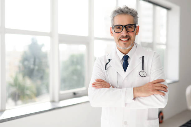 istock Experienced confident senior doctor with grey hair 2012888021
