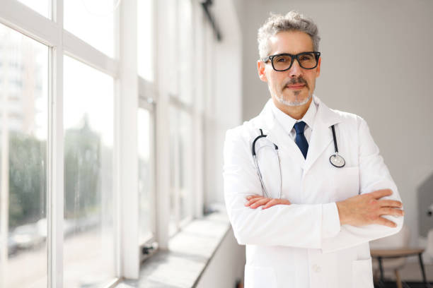 istock Experienced confident senior doctor with grey hair 2012888024