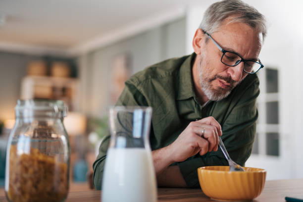 istock Close-up senior  man is having breakfast 2012917593