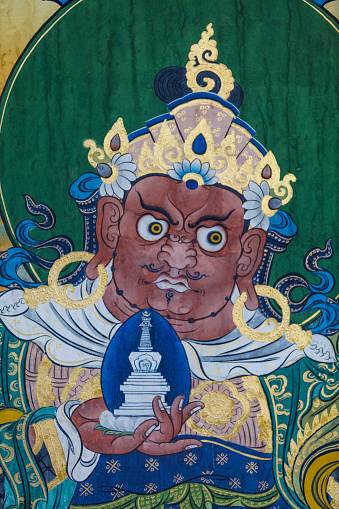 A detail of a worn painting on a wall in a Tibetan temple in Nepal.