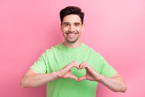 Photo of glad nice man wear trendy green clothes showing you heart figure isolated on pink color background.