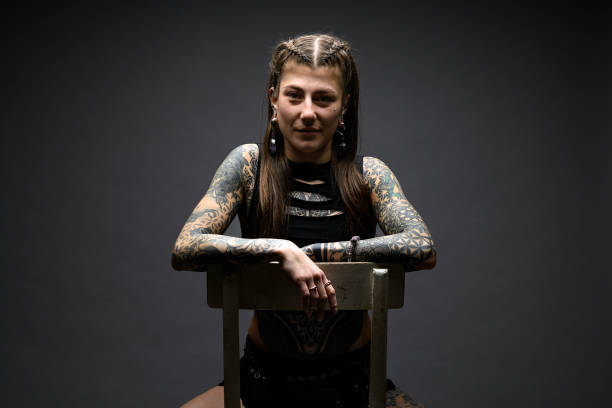 istock Tattooed girl studio portrait on gray background 2012937287