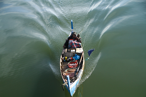 Sigli,Aceh  01/01/2000, traditional fishing boats exit the river into the ocean to look for fish.