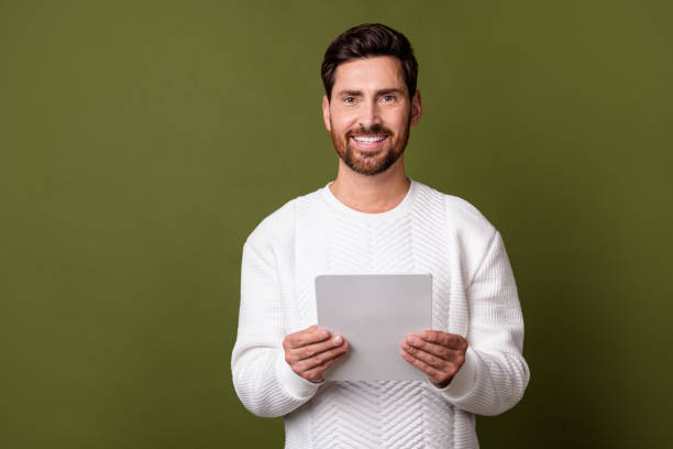 istock Photo of nice positive man successful office agent promoting modern technology empty space isolated on khaki color background 2012941894