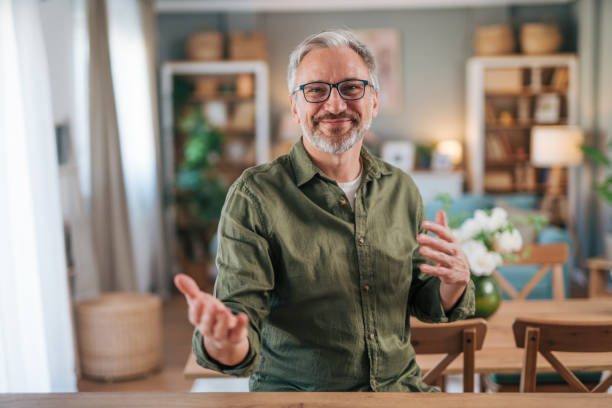 istock Happily smiling elderly man standing in his new apartment 2012950945