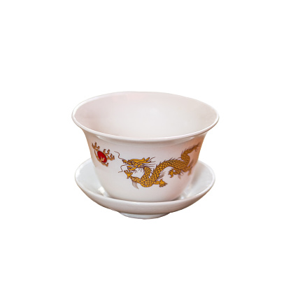 Chinese porcelain cup with dragon on white background