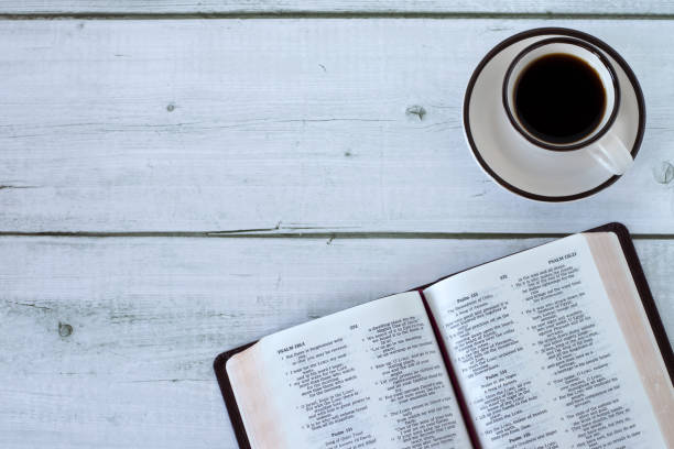 istock Open holy bible book with coffee cup on wooden background, top view 2012952020