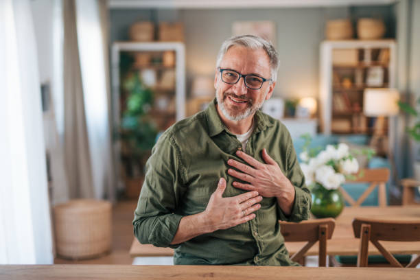 istock Happily smiling elderly man standing in his new apartment 2012952069