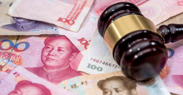istock yuan on wooden hammer . close up. 2012961270
