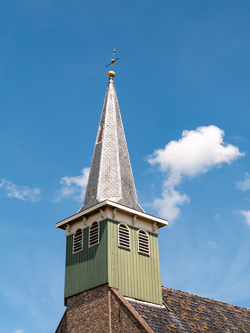 Wooden tower with constricted spire of Haghakerk, church in center of Heeg, Friesland, Netherlands