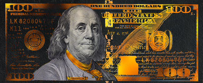 golden textured 100 US dollar banknote with black background for design purpose