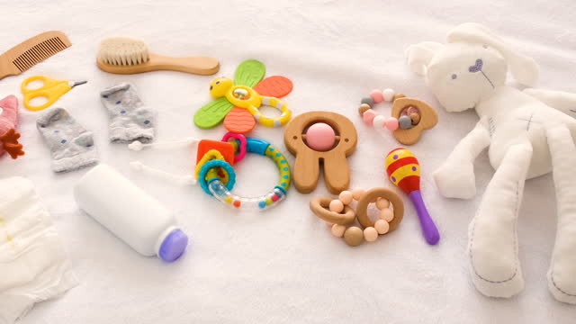 baby toys and accessories on the bed. selective focus. kid.