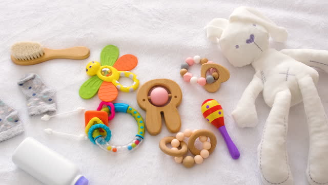 baby toys and accessories on the bed. selective focus. kid.