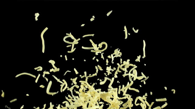 The grated cheese flies up and falls down. Filmed on a high-speed camera at 1000 fps.