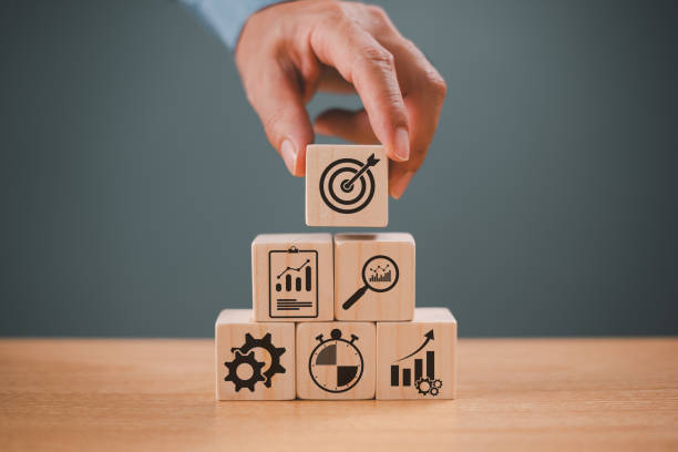 istock Goal aim target concept. Goal setting planning focus for future. Hand push target board on wooden cube block icon for creative set up business success objective. Achievement winner business project 2013041688