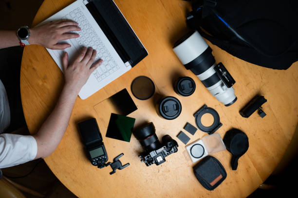 istock photographer workplace, camera and accesories, working on the laptop 2013045577