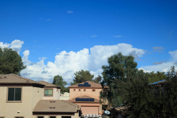 istock Typical house roofs under rising cumulus clouds 2013067573