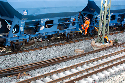 Frankfurt, Germany - February 05, 2024: Railroad construction site in Frankfurt-Eschersheim - track workers laying rail tracks and building a railroad station platform