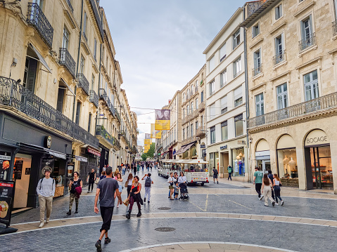 Montpellier, France - 22 May, 2023: People walking in the city center. The comercial area, near the Place de la Comedie square, is famous by its stores, monuments and restaurants.