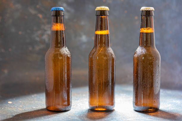 three bottles of beer on stage with spotlight - protagonist photos et images de collection