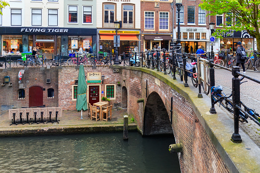 Utrecht, Netherlands- April 16, 2017: Iconic split level canal  in the  heart of the historic city with people enjoying sunny spring day - lively Dutch atmosphere.