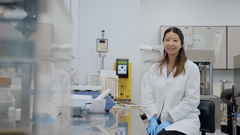 Confident mid adult female scientist working in lab