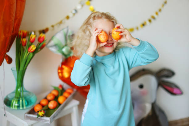 istock girl with easter eggs near her eyes 2013093511