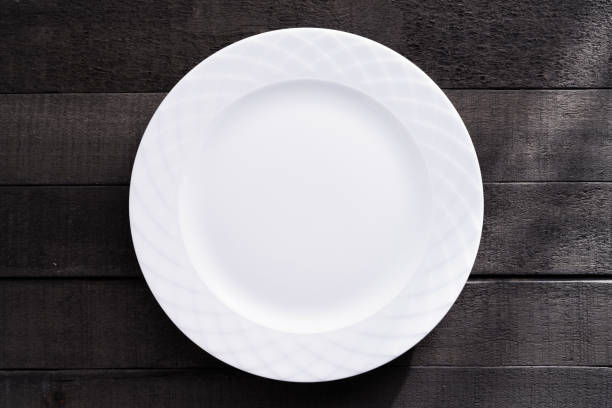 istock Blank white large plate on wood background 2013112531