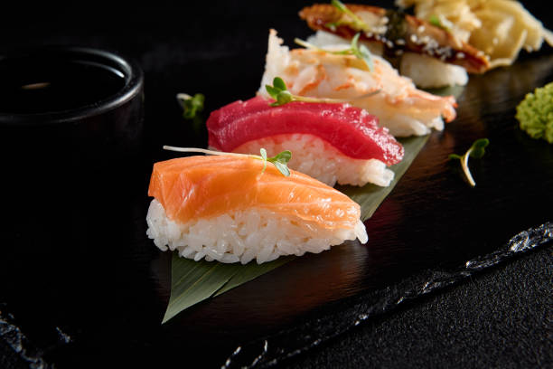 istock Classic nigiri sushi with salmon, tuna, eel, and shrimp on a black slate 2013146293