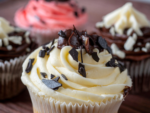 a set of delicious and sweet chocolate cupcakes on a wooden background. High-calorie dessert, selective focus