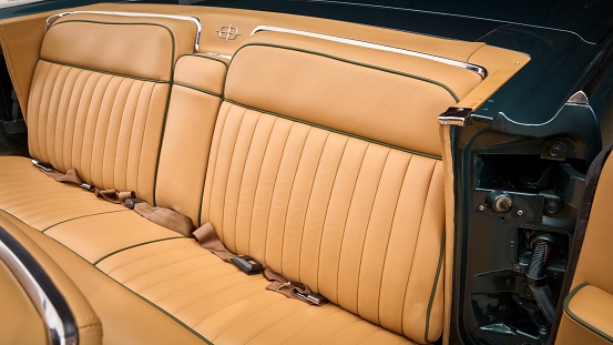 Rear tan leather bench seat in a car