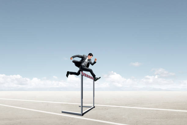 istock Man In Suit Jumping Over A Hurdle 2013211303