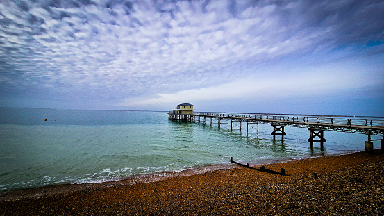 Totland Bay, Isle of Wight with beautiful clouds and sea view past the pier.