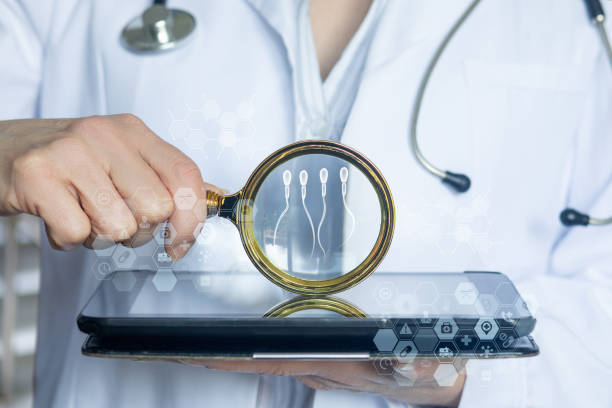 istock Doctor uses magnifying glass to show sperm. 2013237672