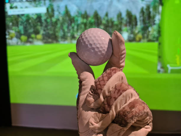 istock Golfers holding a golf ball indoors 2013246751