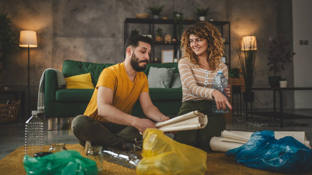 istock husband and wife recycle at home sorting waste plastic paper and glass 2013247546